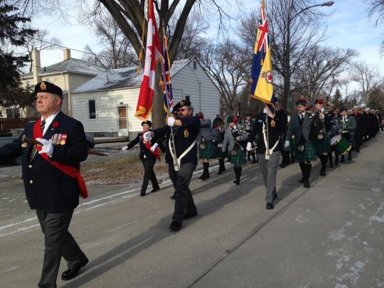 The Remembrance Day Parade begins with the Color Party leading the way.